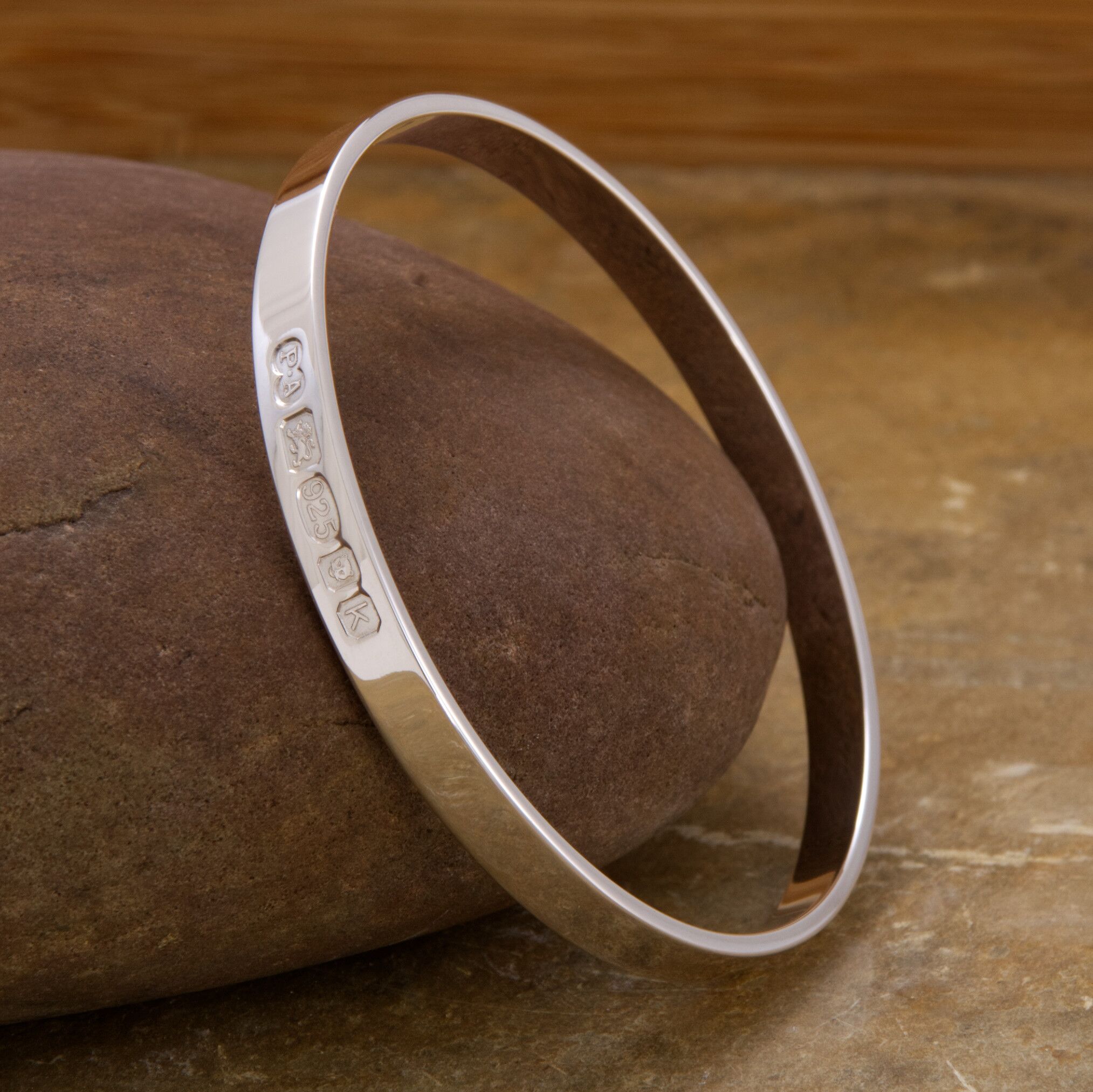 Zennor Solid Sterling Silver Bangle Outside Hallmarks 2 The Zennor Solid Sterling Silver Bangle handmade in Cornwall. Solid Silver bracelet. London Hallmarks on the outside - 6mm wide.