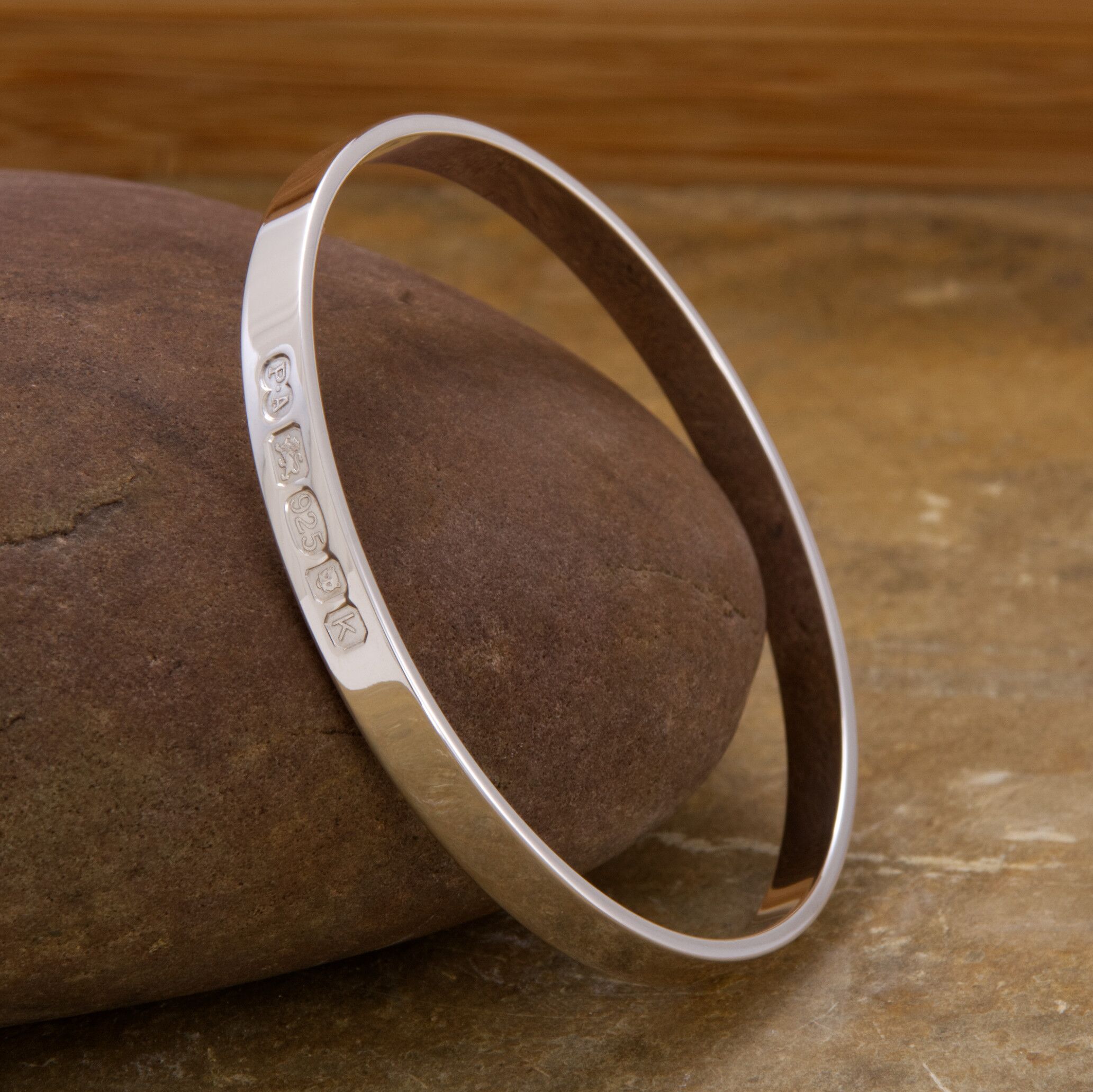 Zennor Solid Sterling Silver Bangle Outside Hallmarks 1 The Zennor Solid Sterling Silver Bangle handmade in Cornwall. Solid Silver bracelet. London Hallmarks on the outside - 6mm wide.