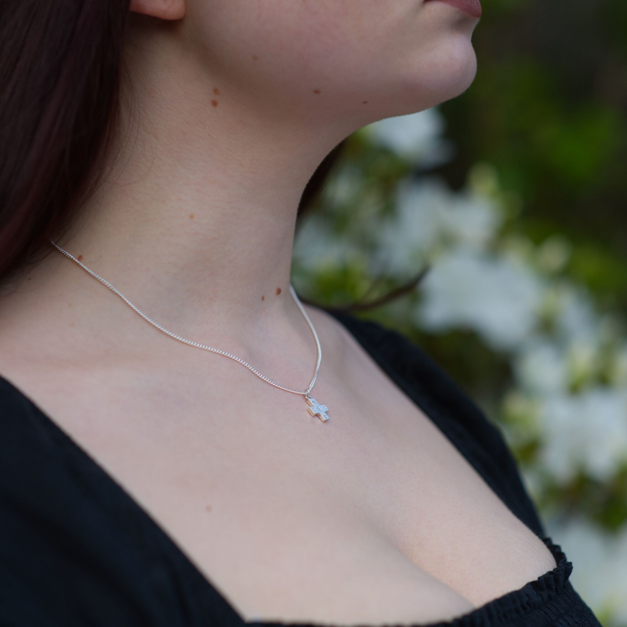 Solid Silver Millennium Cross Pendant & Chain - Small 2 small Solid Silver fine 925 Millenium cross pendant, london hallmarked being worn on a silver chain by a woman by kerensa