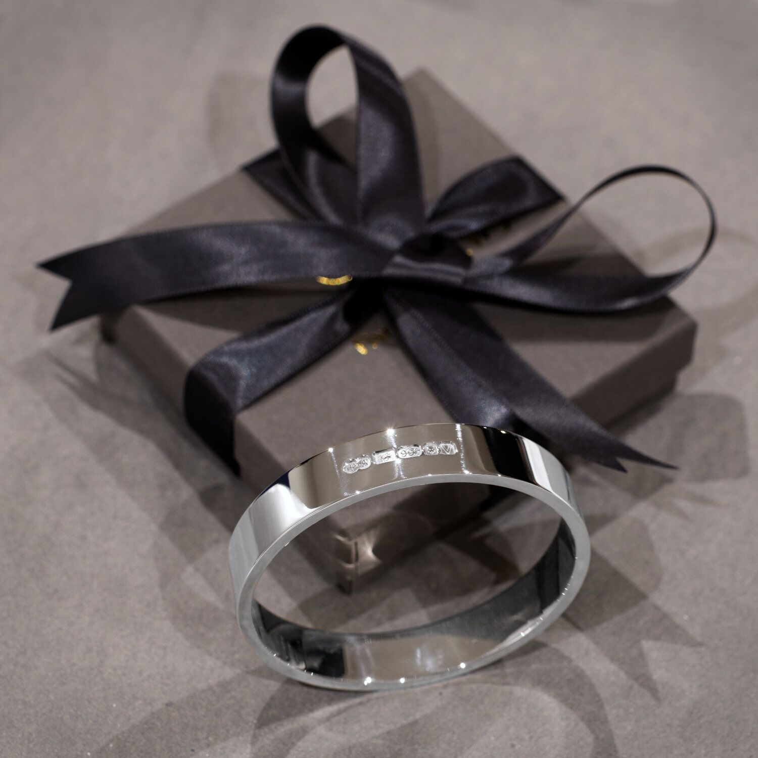 Zennor 12 Extra Heavy Chunky Solid Sterling Silver Bangle 4 Zennor 12 is an Extra Heavy, Chunky Solid Silver Bangle, Handmade in Cornwall. It is a Solid Silver Bracelet with display London Hallmarks - 12mm wide. Featured next to the Kerensa Jewellery gift box with ribbon